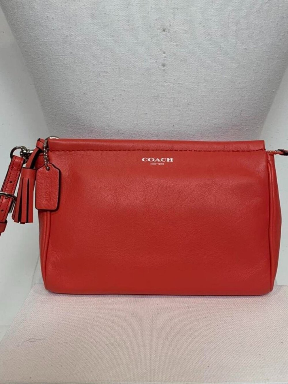 Coral-red orange leather Coach wristlet